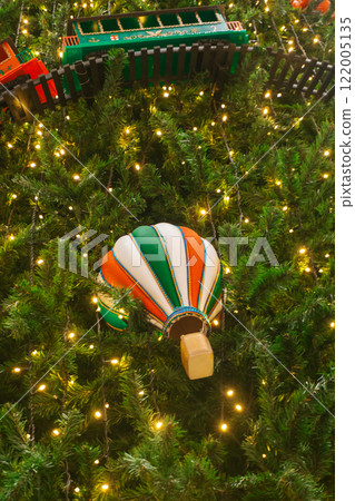 New Year's toys on the Christmas tree. festive Christmas decoration on an artificial Christmas tree New Year's toys on the Christmas tree. festive Christmas decoration on an artificial Christmas tree 122005135