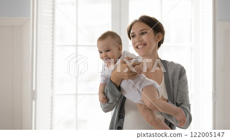 Happy excited little infant kid sit on caring mommy hands 122005147