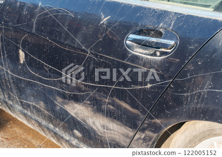 A broken, abandoned blue car on the side of the road. looted premium car before repair 122005152
