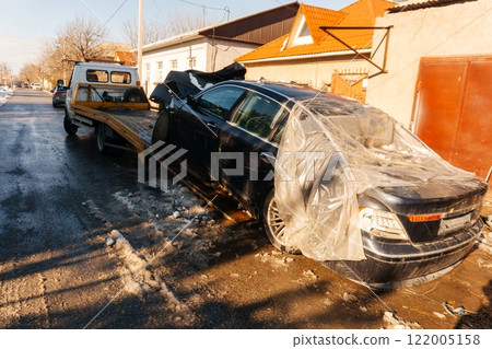 evacuation of an emergency vehicle from the road. loading a wrecked car onto a tow truck 122005158