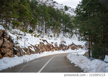 View of mountain road in winter time in Montenegro, Lovcen national park  122005215
