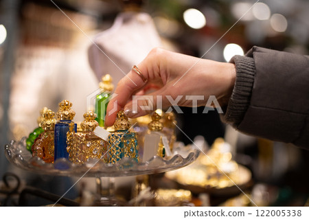 Woman's hand choosing a small bottle 122005338