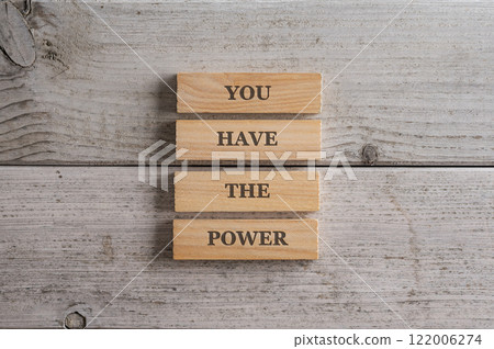 Stack of four wooden pegs with a You have the power sign on them Stack of four wooden pegs with a You have the power sign on them 122006274