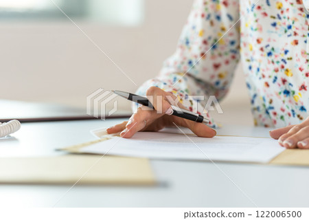 Businesswoman proofreading a contract 122006500