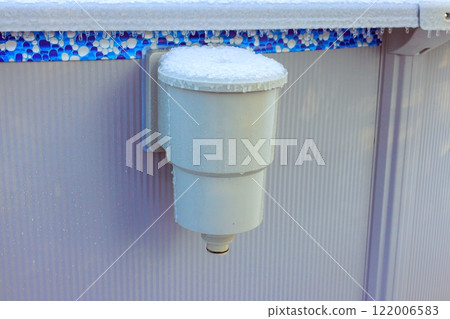 Frost builds up on pool skimmer attached to an above ground pool during icy frigid winter day. 122006583