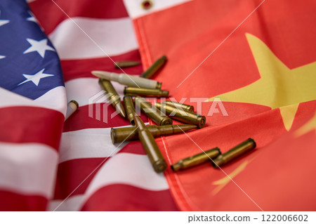 Cartridges and bullets of different sizes on top of the American and Chinese flag. 122006602