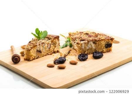 Ruddy sponge cake with prunes and nuts for tea, isolated on white background Ruddy sponge cake with prunes and nuts for tea, isolated on white background 122006929