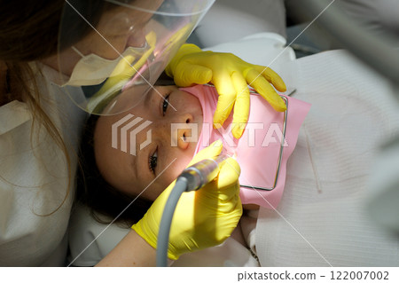 Children's dentistry. Live funny photo of a laughing child at the dentist's appointment. 122007002