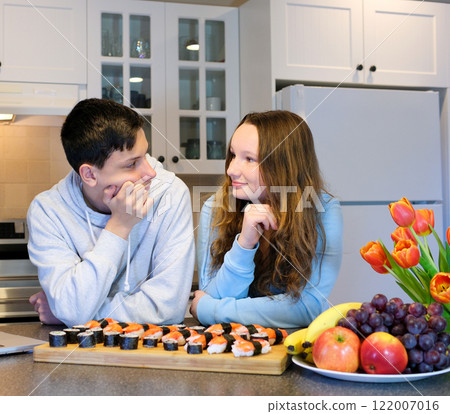 Sushi, food and chef at restaurant cooking on table at diner or cuisine with ingredients at night. Kitchen, fish and culinary artist preparing gourmet Japanese meal or snack with fish at catering job 122007016