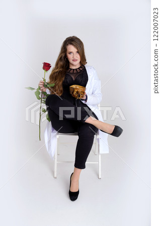 Elegance, celebration and party concept. Attractive young happy woman having birthday, receiving gifts, beautiful flowers, holding roses and champagne glass 122007023