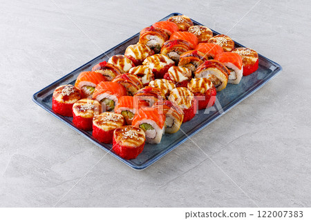 Japanese sushi rolls, sushi sets on a gray background for restaurant menu and food delivery Japanese sushi rolls, sushi sets on a gray background for restaurant menu and food delivery 122007383
