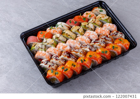 Japanese sushi rolls, sushi sets on a gray background for restaurant menu and food delivery Japanese sushi rolls, sushi sets on a gray background for restaurant menu and food delivery 122007431