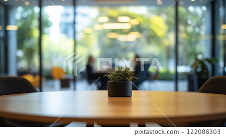 Corporate meeting room featuring a blurred round table and greenery 122008303