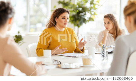 Business meeting with diverse group of women discussing ideas in bright office, gender equality concept 122008460