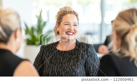 Business meeting with diverse group of women discussing ideas in bright office, gender equality concept 122008461
