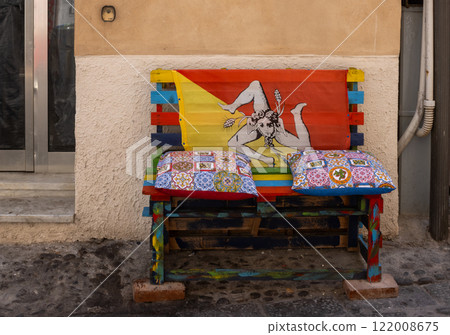 Bench on the street with sicilian flag, Cefalu, Sicily, Italy 122008675