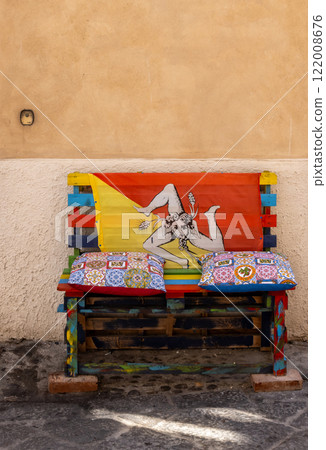 Bench on the street with sicilian flag, Cefalu, Sicily, Italy Bench on the street with sicilian flag, Cefalu, Sicily, Italy 122008676