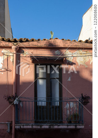 Balcony of an old red house, Cefalu, Sicily, Italy 122008680