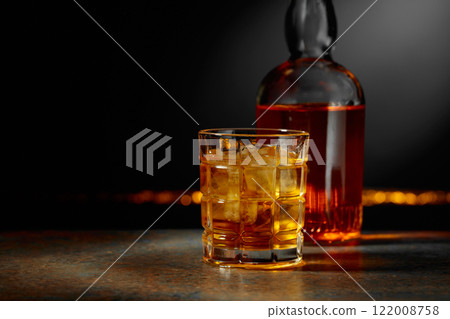 Whiskey with ice on a dark background. Whiskey with ice on a dark background. 122008758