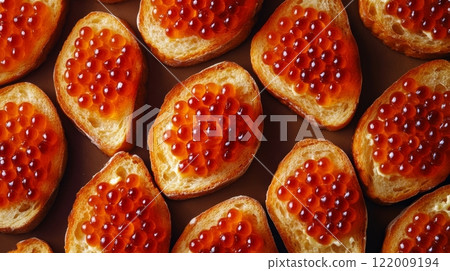 Toasted bread with red caviar arranged in a pattern, gourmet appetizer. Luxury dining and culinary concept 122009194