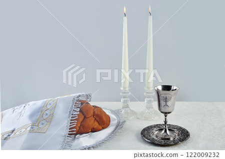 Sabbath Table Setting. Challah bread, candles, and a kiddush cup 122009232