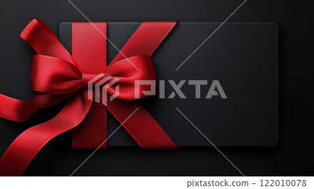 Elegant black gift card with a luxurious red ribbon and bow, copy space 122010078