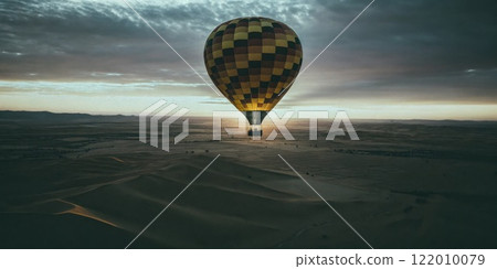 Hot Air Balloon Flying Over Deserted Sand Dunes at Sunrise 122010079