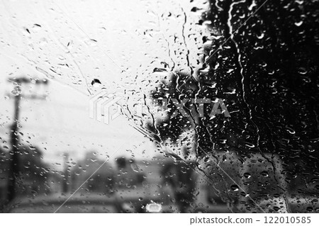 Car window glass on a rainy day 122010585