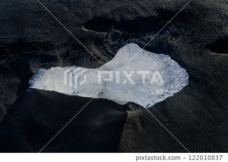 Loose segments of glacier washed out of Jokulsarlon glacial lake onto Diamond Beach on Iceland Loose segments of glacier washed out of Jokulsarlon glacial lake onto Diamond Beach on Iceland 122010837