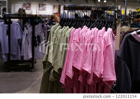 Colorful fashion display in a modern retail store showcasing various t-shirts 122011154
