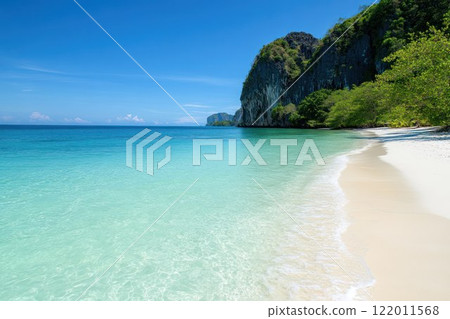 Scenic tropical beach with crystal clear blue waters and white sandy shores. 122011568