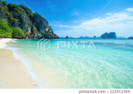 Scenic tropical beach with crystal clear blue waters and white sandy shores. 122011569