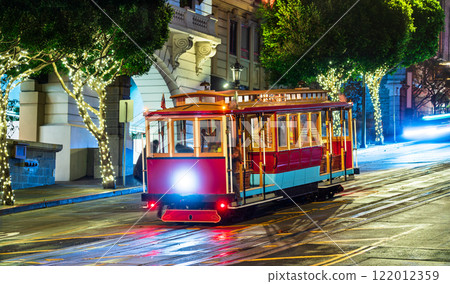 Iconic San Francisco cable car illuminated at night at the intersection of California Street and Powell Street, California, United States 122012359