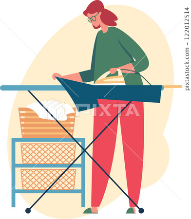 Young woman ironing clothes on an ironing board, surrounded by a basket of freshly laundered linen, engaging in routine housework and maintaining a tidy home environment 122012514