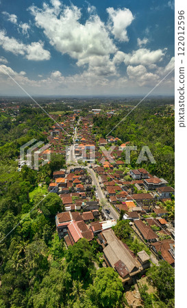 Aerial view of a picturesque village surrounded by lush greenery and stunning landscapes 122012596