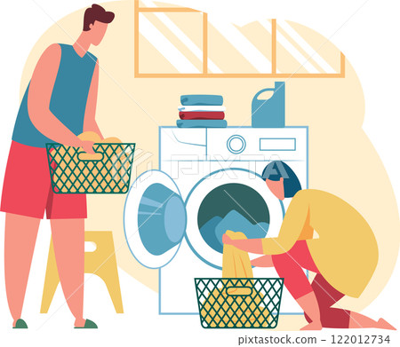 Man carrying basket full of dirty clothes and woman loading washing machine with laundry in the laundry room, performing daily household chores 122012734