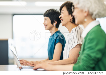 Middle-aged and senior women having a meeting Middle-aged and senior women having a meeting 122012774
