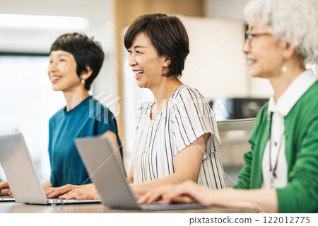 Middle-aged and senior women having a meeting Middle-aged and senior women having a meeting 122012775