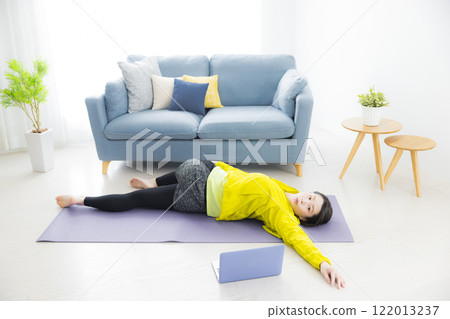 A young woman stretching A young woman stretching 122013237
