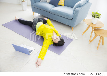 A young woman stretching A young woman stretching 122013238