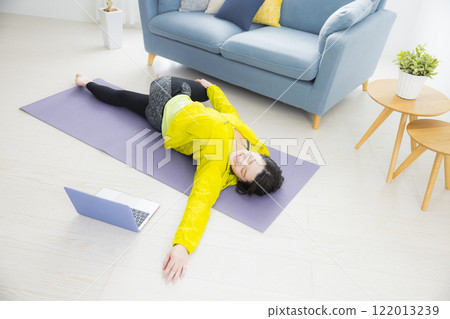 A young woman stretching 122013239