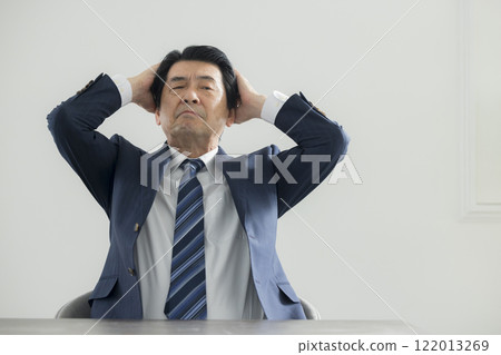 Businessman holding his head Businessman holding his head 122013269