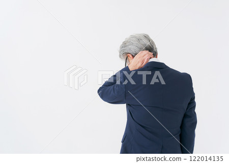 Senior man in a suit holding his head Senior man in a suit holding his head 122014135