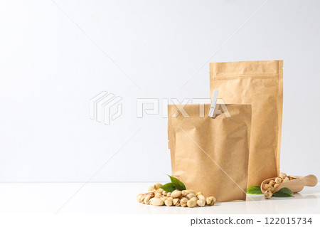 Pistachios in a craft bag, on a light background. Pistachios in a craft bag, on a light background. 122015734