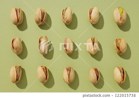 Pistachios, on a green background, top view. 122015738