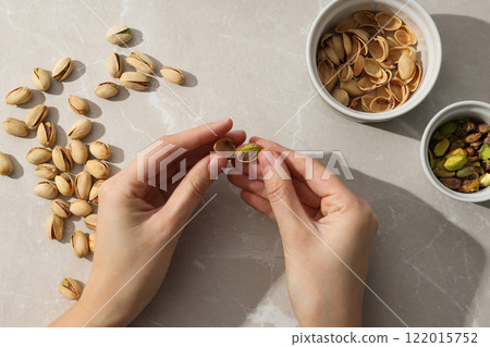 Pistachios in a glass plate, top view. 122015752
