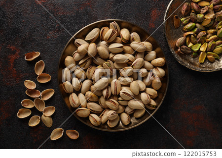Pistachios in a plate, on a dark background. Pistachios in a plate, on a dark background. 122015753