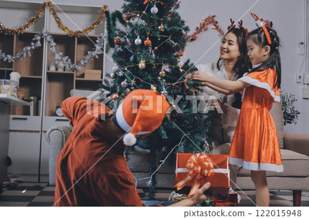 Father, mother and child celebrating Christmas. Father, mother and child celebrating Christmas. 122015948