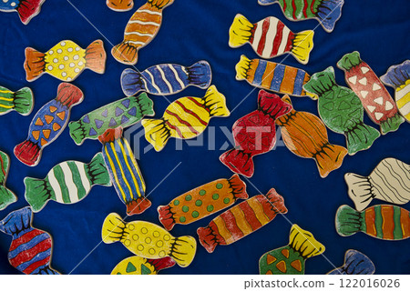 There are lots of candy toys on a blue cloth. There are lots of candy toys on a blue cloth. 122016026