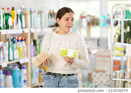 woman chooses clothespins for her home 122016074